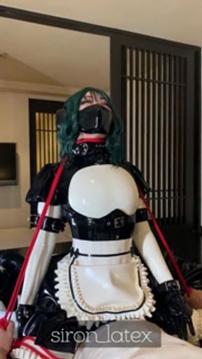 Tightening a red string around the neck of a rubber doll