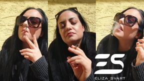 Smoking a Marlboro red in the sun and chewing a gum
