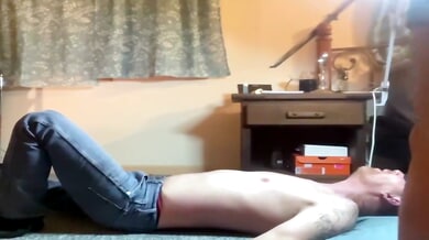 Bound and trampled under her feet in a dim bedroom