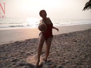 Worthy lady at lonely nudist beach. Red swimsuit. Red bikini. Coconut