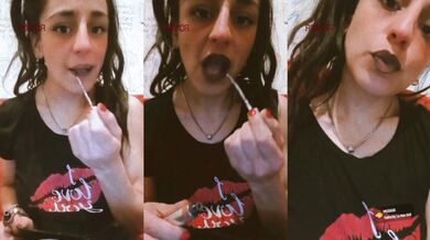 Her glossy lips part while she smokes tongue out makeup glistening