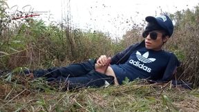 Cute gay Asian twink Jon Arteen speaks French wanks his smooth penis in the rain, lubricated with