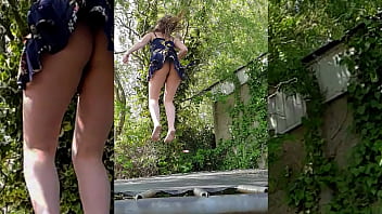 Girl in skirt jumping on a trampoline with perfect ass in slow motion