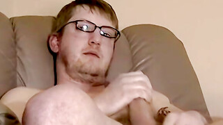 Tattooed amateur with glasses is stroking his massive dick