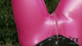 Latex wearing chick is sucking hard stick being hanged up side down