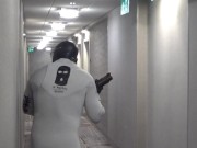 horny wetsuited armed guard patrolling hotel hall