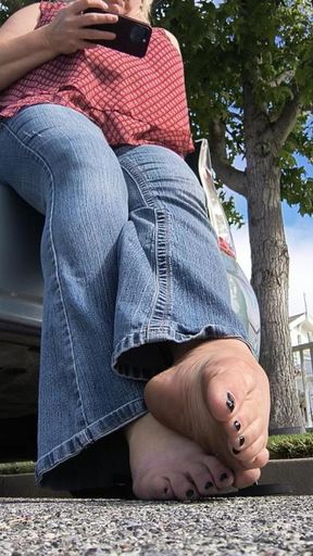 legs wrapped up in blue jeans. bare mature feet peeking out. a delicious combination you can't resist.