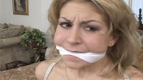 Pretty Brianna is Tied to a Bed Post, A Cleave Gag in Her Mouth and Nice, Perky Tits Exposed!