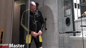 Rubber Man Pisses with Uncut Cock