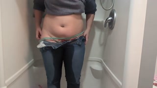 Naughty girl desperately pisses jeans in shower