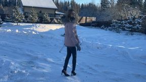 girl walks on ice in high heels and slips