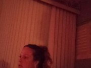 Milf with big boobs showing off cleavage while playing video games and smoking at same time