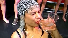 Dirty European slut kneeling in front of few guys and drinking their