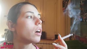 Tempting Italian girl smokes a cigar in a close up video
