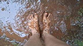 Jessie gets her feet dirty in the mud puddle