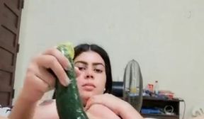 Beautiful indian girl with cucumber