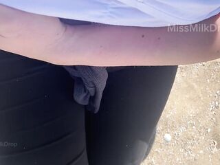 Hand expressing breastmilk at the beach!