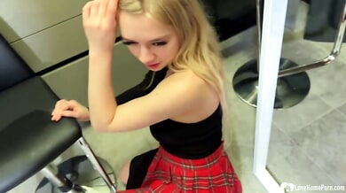 Long-haired blonde girlfriend goes down on her muscular boyfriend in the kitchen