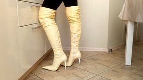 A pretty girl in high heels prepares a meal