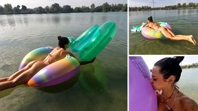 Jade blowing two inflatable rings on the lake