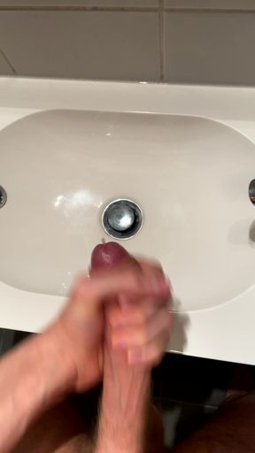 Young twink jacks it in the bathroom with a big dick and cumshots