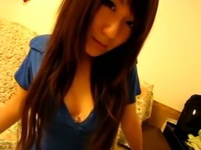 Asian hussy shows her tits and fucks her hairy vag with a cucumber