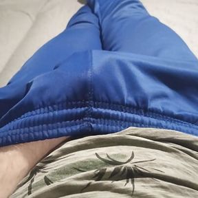 Guy in blue sweatpants rubbing his bulge