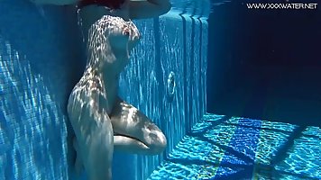 Tattooed brunette, Sheril Blossom likes to get naked and play with herself in the swimming pool