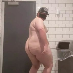 Chubby guy strips naked in bathroom.