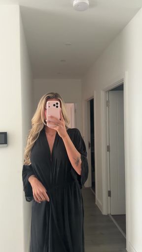 Woman in black dress taking selfie