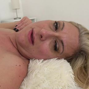 A MILF with big tits and a sexy bush has some solo fun on camera