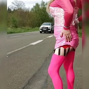 sissy in pink outfit by the road shows her ass and clit