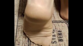 different footplay in tan nylons
