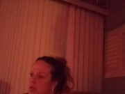 Milf with big boobs showing off cleavage while playing video games and smoking at same time
