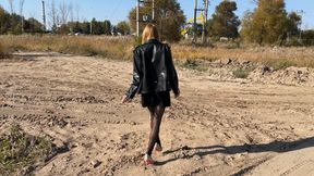 girl in high heels and stockings walks through sticky and deep mud in which her shoes get stuck