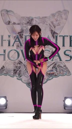 Asian teen in latex plays for the camera