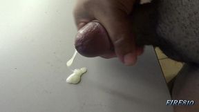 check out how this black cock bust a huge and creamy nut on a table
