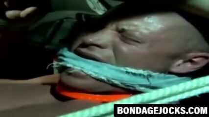 Jock bound with fat rope in outdoor BDSM scene