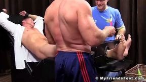 Restrained businessman tickle tormented by dominant guys