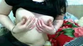 Slutty Asian woman demonstrates her natural tits for the cam