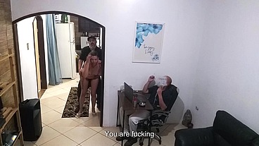 While the husband works, the wife in a towel greets the delivery man.