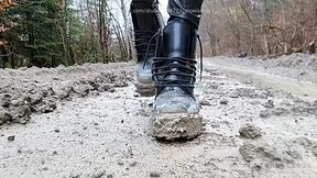 Very dirty Dr Martens boots walking in mud