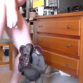 John is peeing on an ape statue