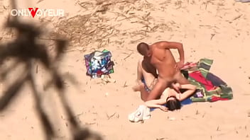 Beach Voyeur. Bikini girl jerking off bf'_s cock until he shoots a load on her