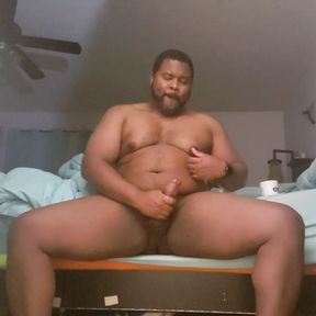 Thick black dick stroking edge of the bed