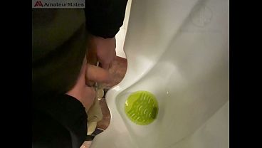 Amateur redhead guy caught pissing in a public toilet'_s urinal - he then quickly plays with his cock before leaving