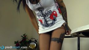 Tattooed beauty Felisja smoking a cigarette while showing off her feet