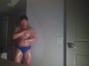 Oiled up and posing while wearing Speedos!