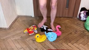 a girl in shorts and a bra tramples various inflatable toys, steps on them and sits down. crash fetish foot fetish