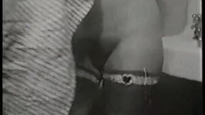Busty cutie in a vintage porn strips down